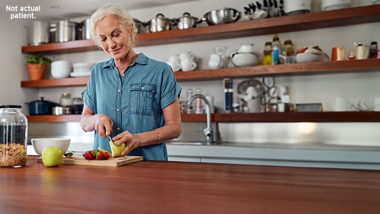 Woman cutting fruit in a kitchen