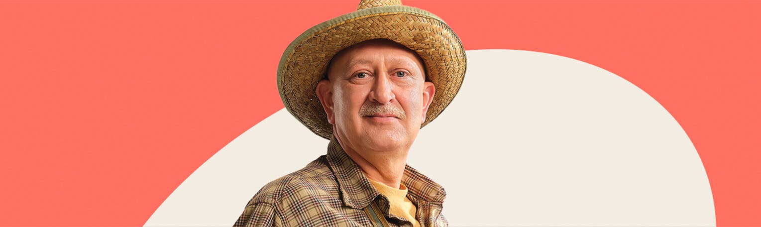 An older white male with a mustache wearing a plaid shirt and straw cowboy hat.