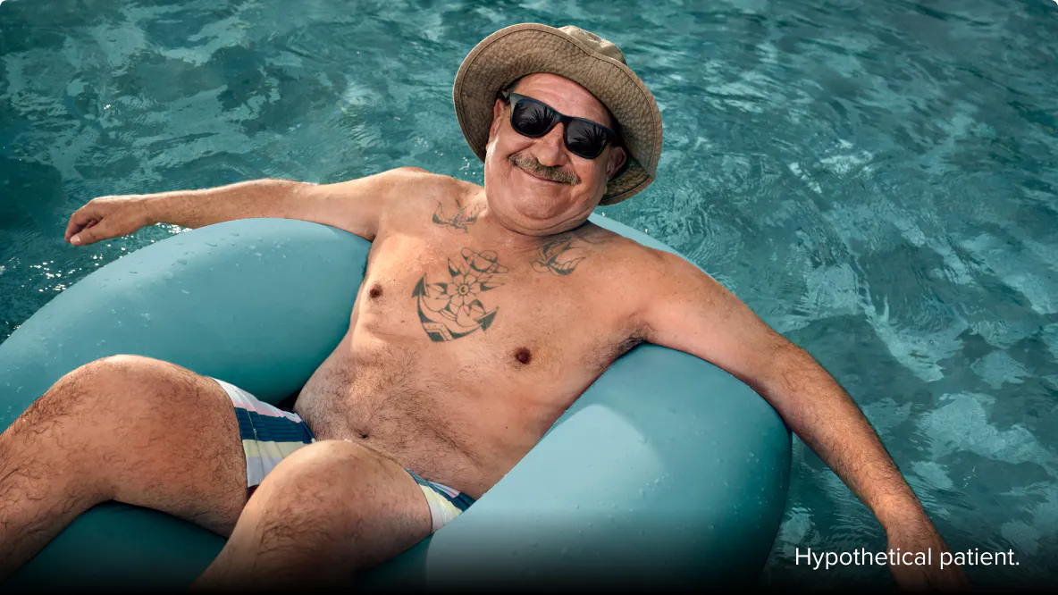 COPD patient Nicholas floating in a pool with a hat and sunglasses