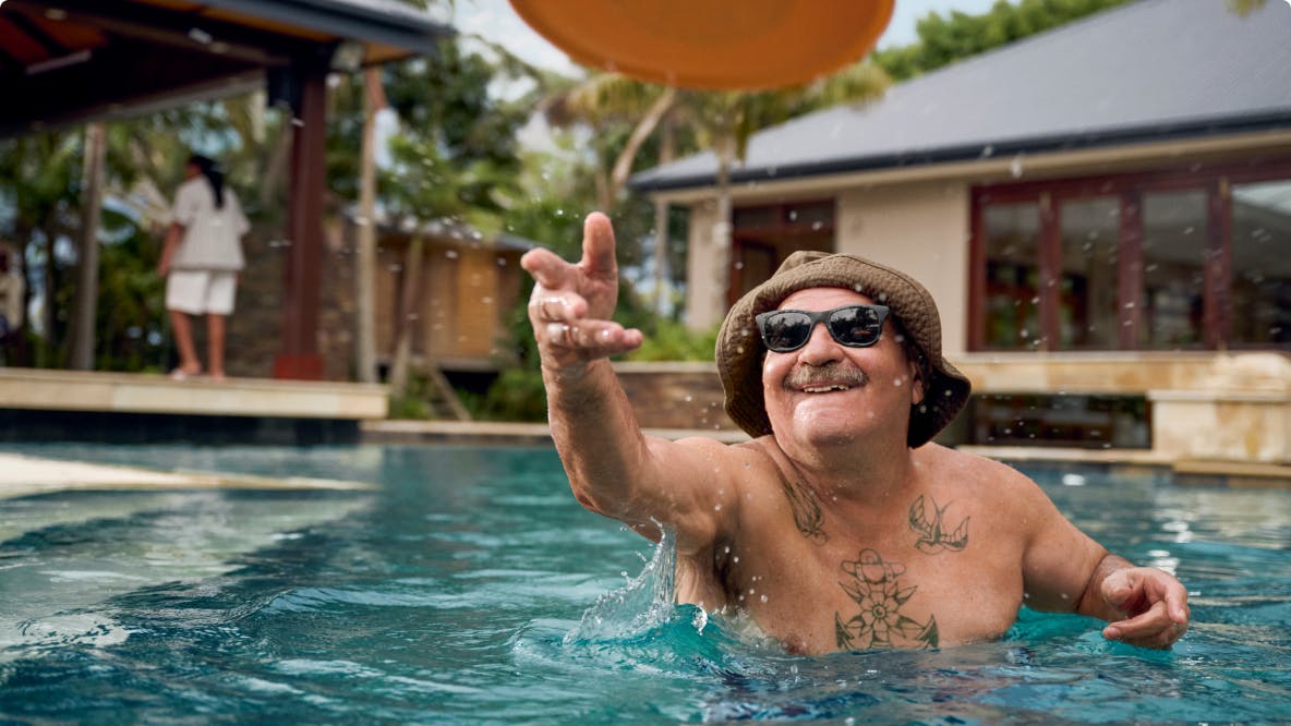 COPD patient Nicholas throwing a Frisbee in an outdoor pool COPD patient Nicholas throwing a Frisbee in an outdoor pool