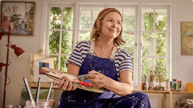 EGPA patient Meredith in studio holding paintbrush and palette EGPA patient Meredith in studio holding paintbrush and palette