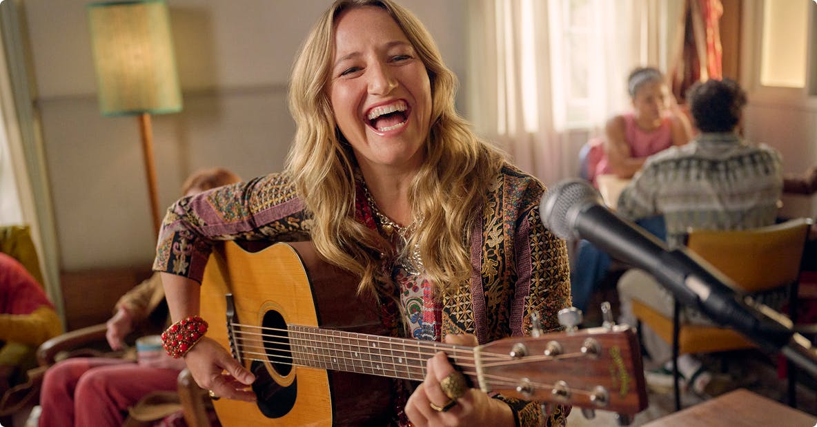 Nasal polyps patient Janet playing guitar in a coffee shop