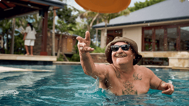 Man throwing a Frisbee in an outdoor pool