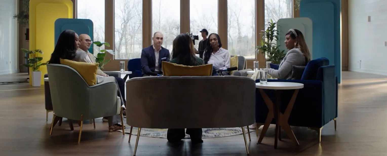 Group of primary care physicians, specialists, and pharmacists sitting in a circle talking