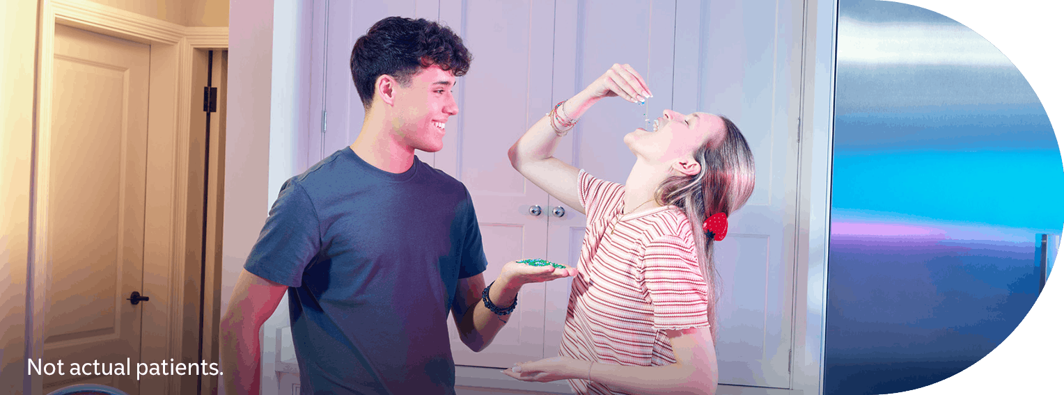 Two young adults in a kitchen. Not actual patients. Vaccination disclaimer included.