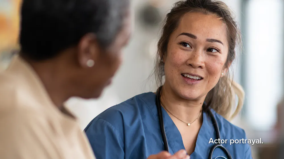 Actor portrayal: female nurse speaking with a female patient 
