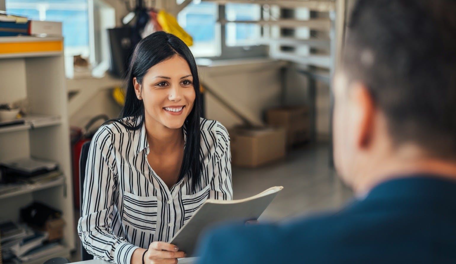 Woman consultant talking with client in office Woman consultant talking with client in office