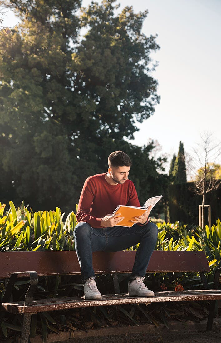 Teen reading outside