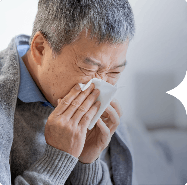 Man sneezing into tissue Image: Adult male sneezing