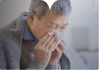 Man sneezing into tissue Image: Adult male sneezing