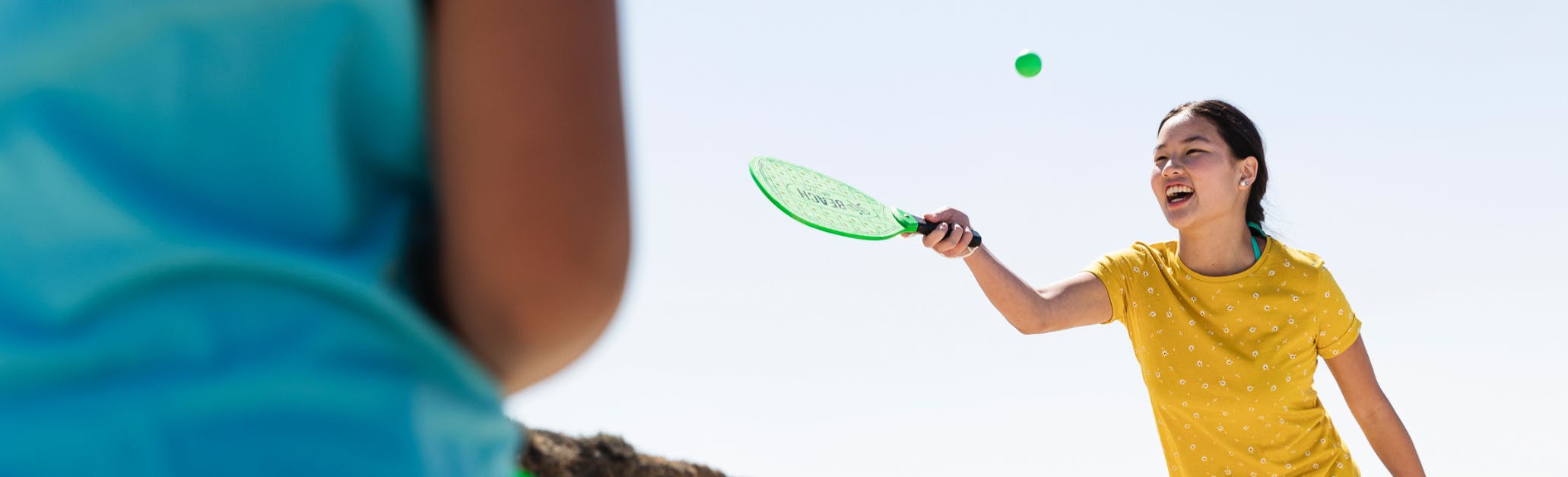 Image of friends playing pickle ball outside