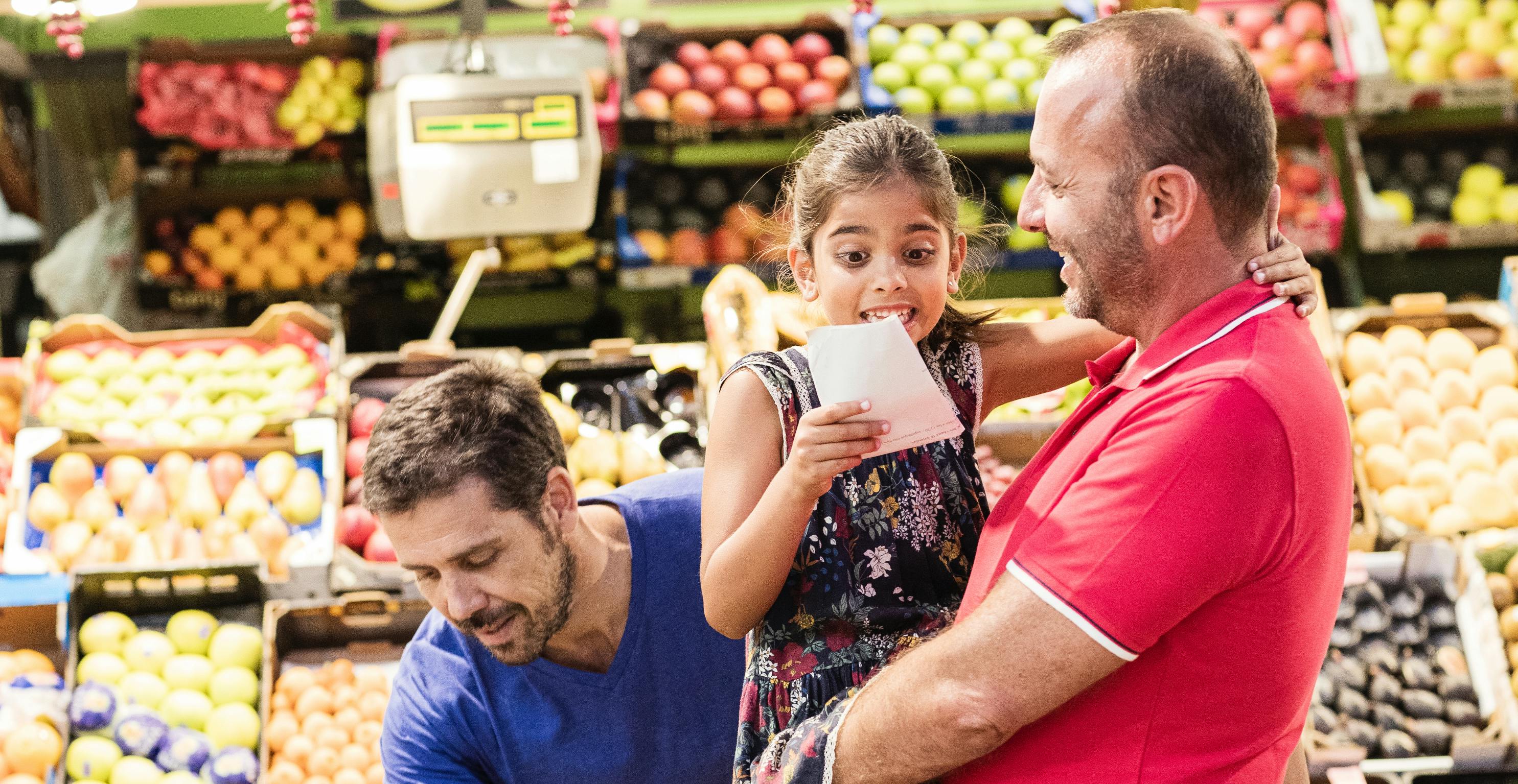 Image of parents at grocery store with daughter