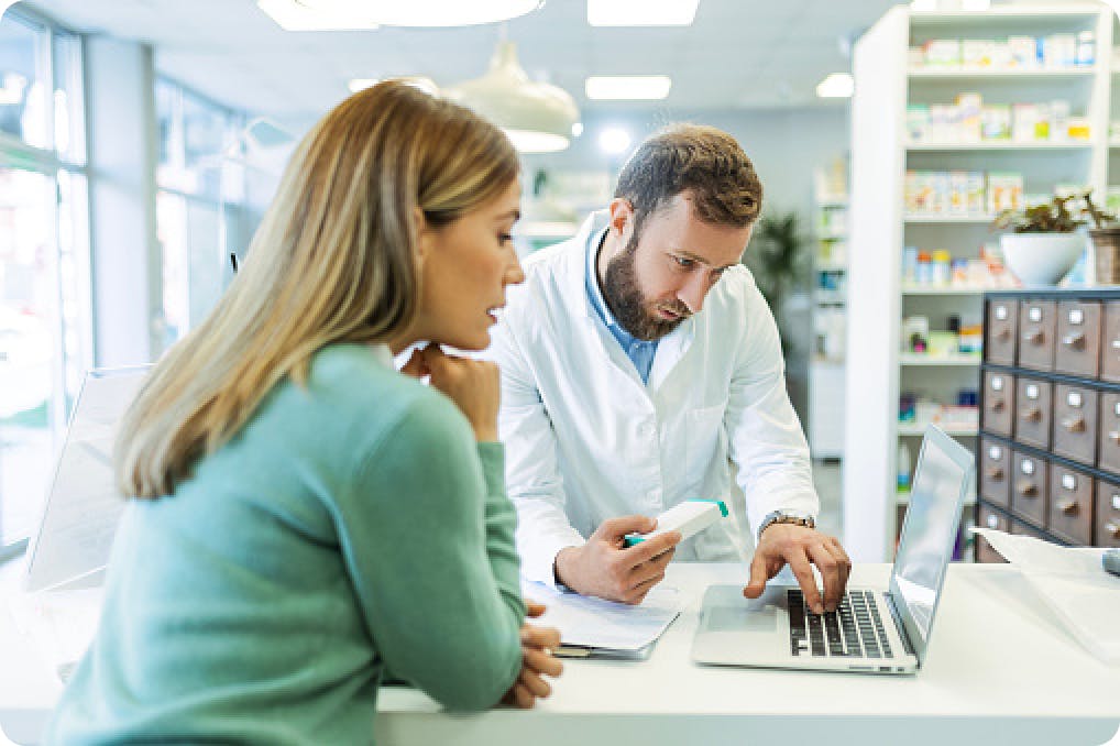Image: Pharmacist showing patient information on laptop 