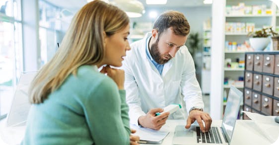 Image: Pharmacist showing patient information on laptop 