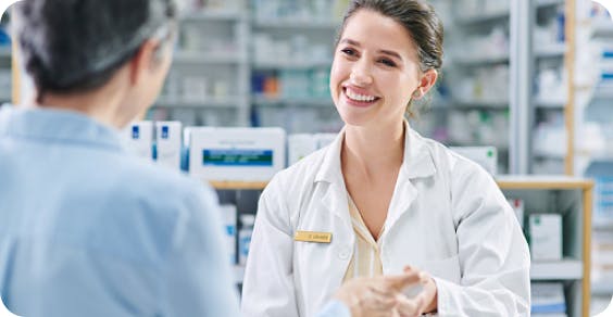 Image: Pharmacist smiling at patient Image: Pharmacist smiling at patient