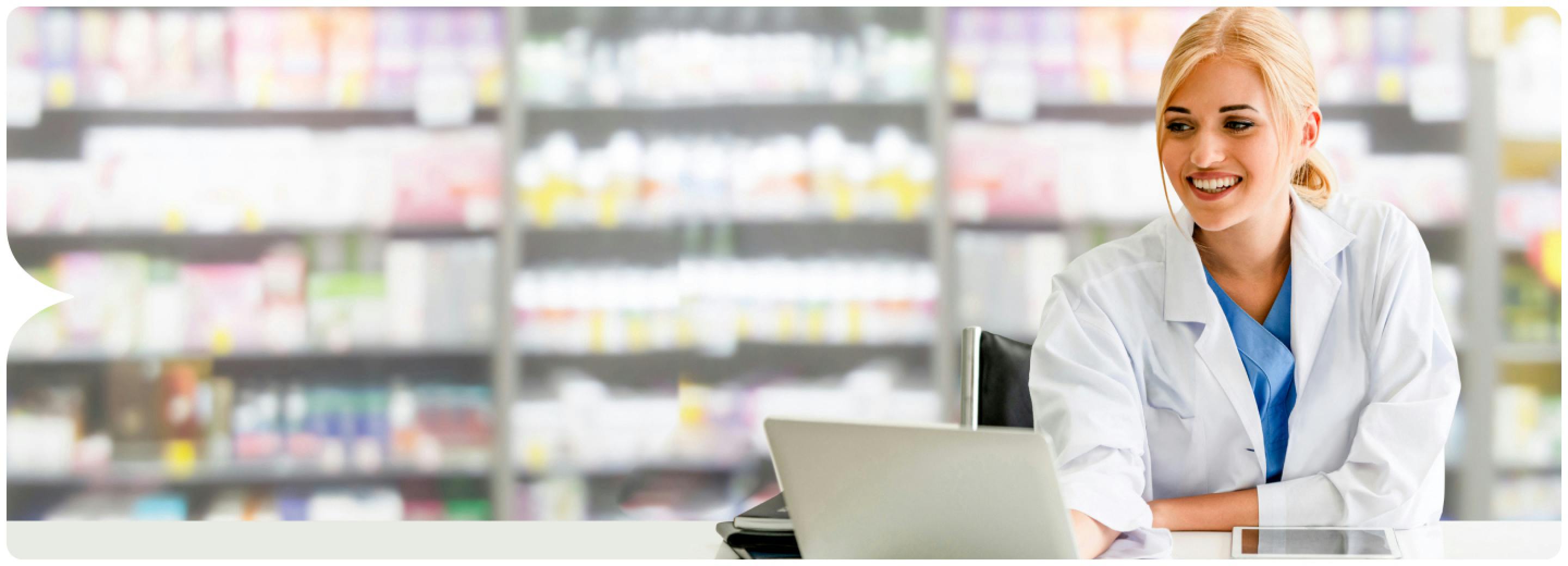 Image: Pharmacist smiling at laptop