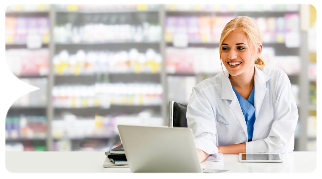 Image: Pharmacist smiling at laptop