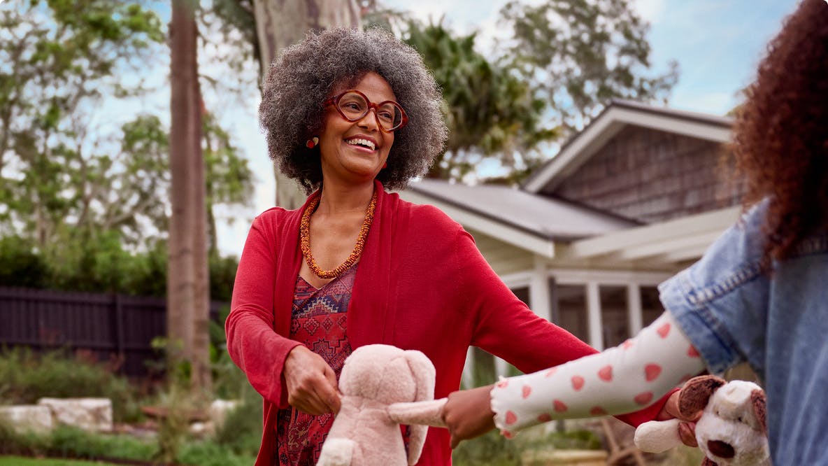 COPD patient Anna holding stuffed animals with her granddaughter