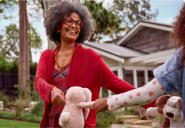COPD patient Anna holding stuffed animals with her granddaughter