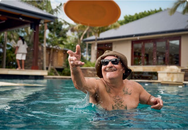 COPD patient Nicholas throwing a Frisbee in an outdoor pool  