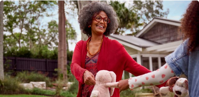 COPD patient Anna holding stuffed animals with her granddaughter