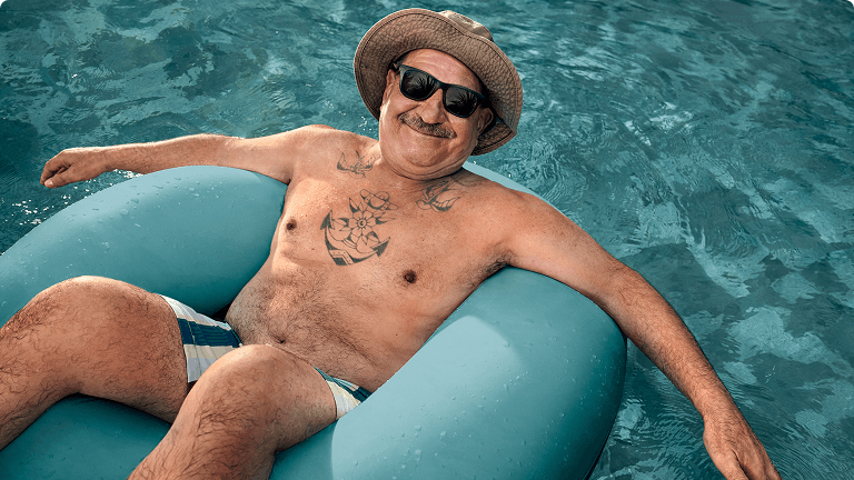 COPD patient Nicholas floating in a pool in an inner tube