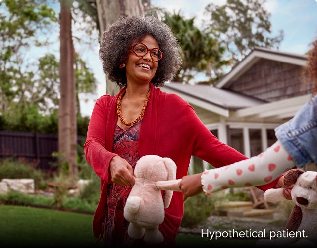 COPD patient Anna holding stuffed animals with her granddaughter