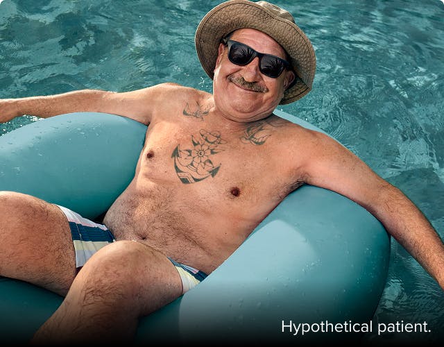 COPD patient Nicholas floating in a pool in an inner tube
