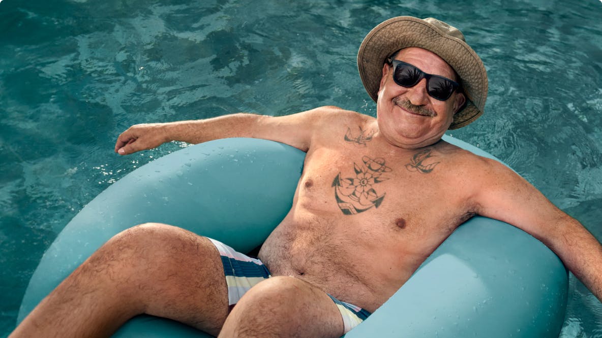 COPD patient Nicholas floating in a pool with a hat and sunglasses