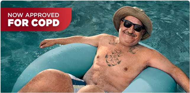 COPD patient Nicholas floating in a pool with a hat and sunglasses