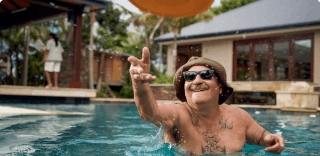 COPD patient Nicholas throwing a Frisbee in an outdoor pool