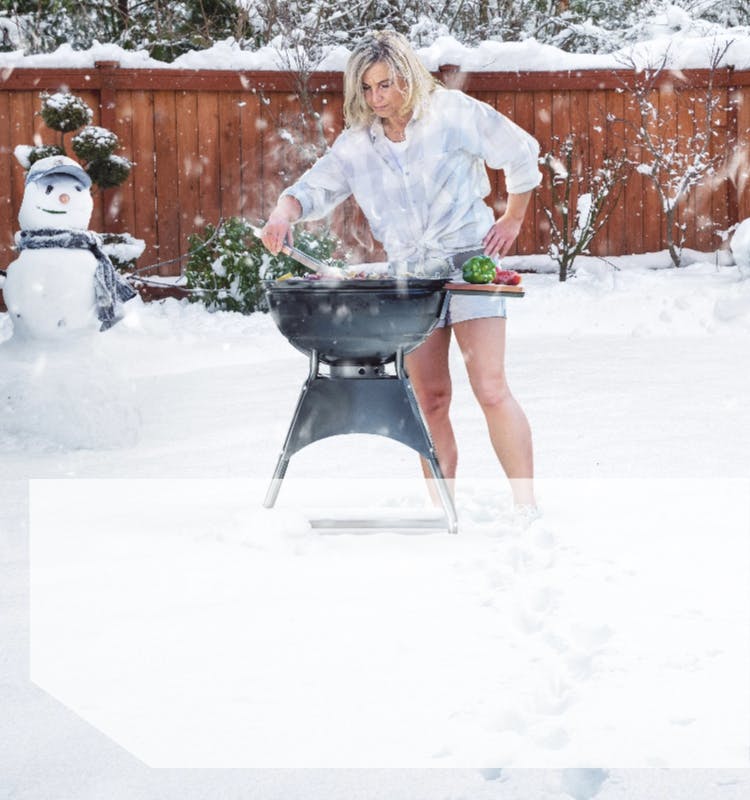 Woman grilling in the snow