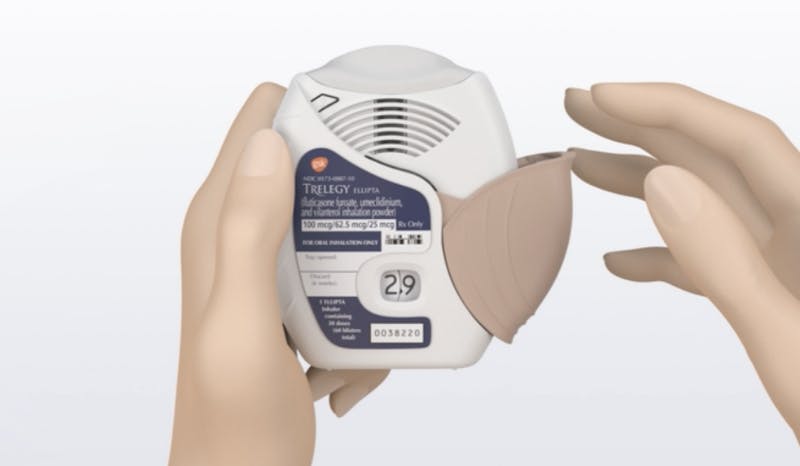 Illustration of a hand opening a TRELEGY ELLIPTA inhaler
