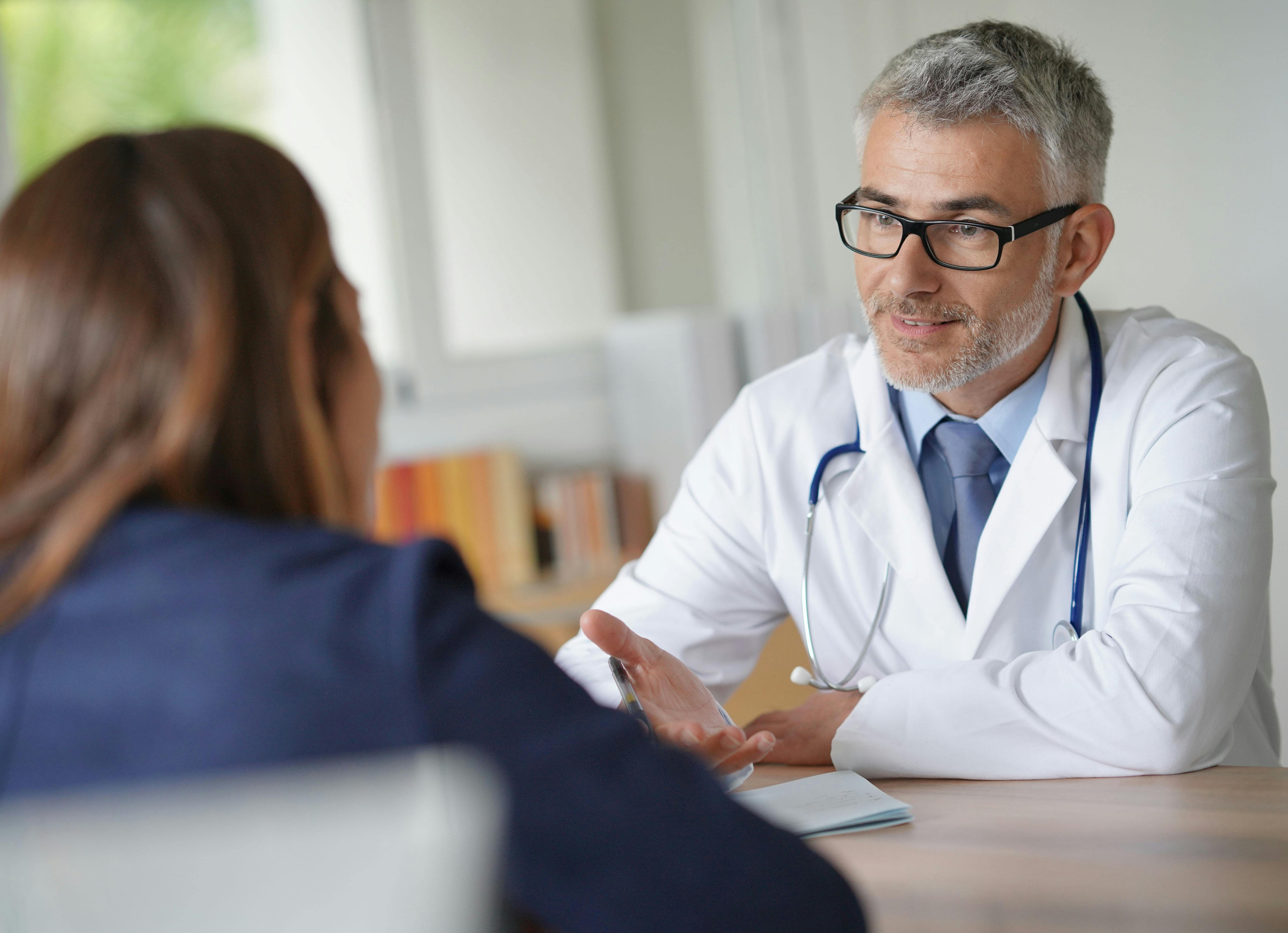 Doctor with patient in clinic room