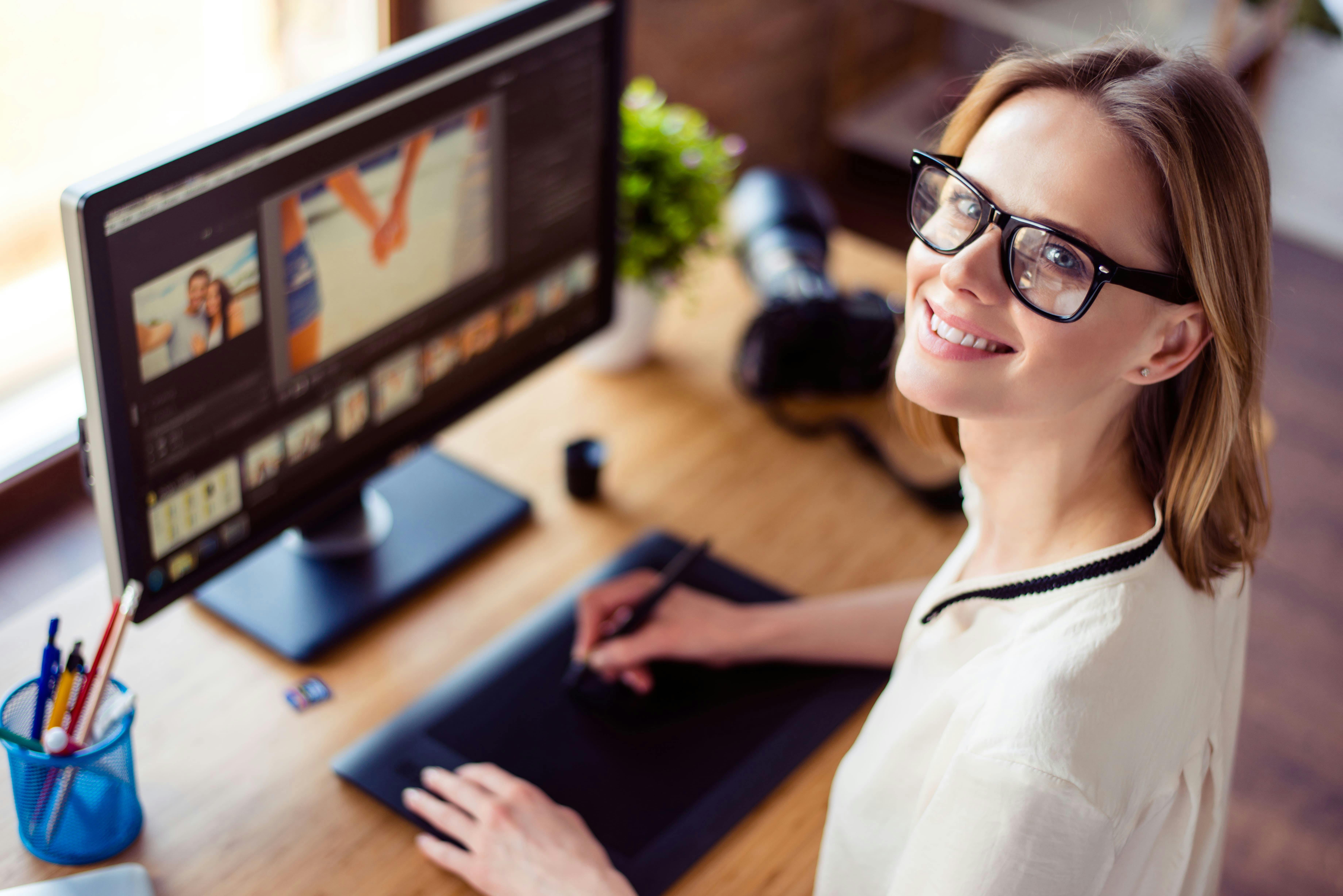 Top view of intelligent blond young woman working with computer