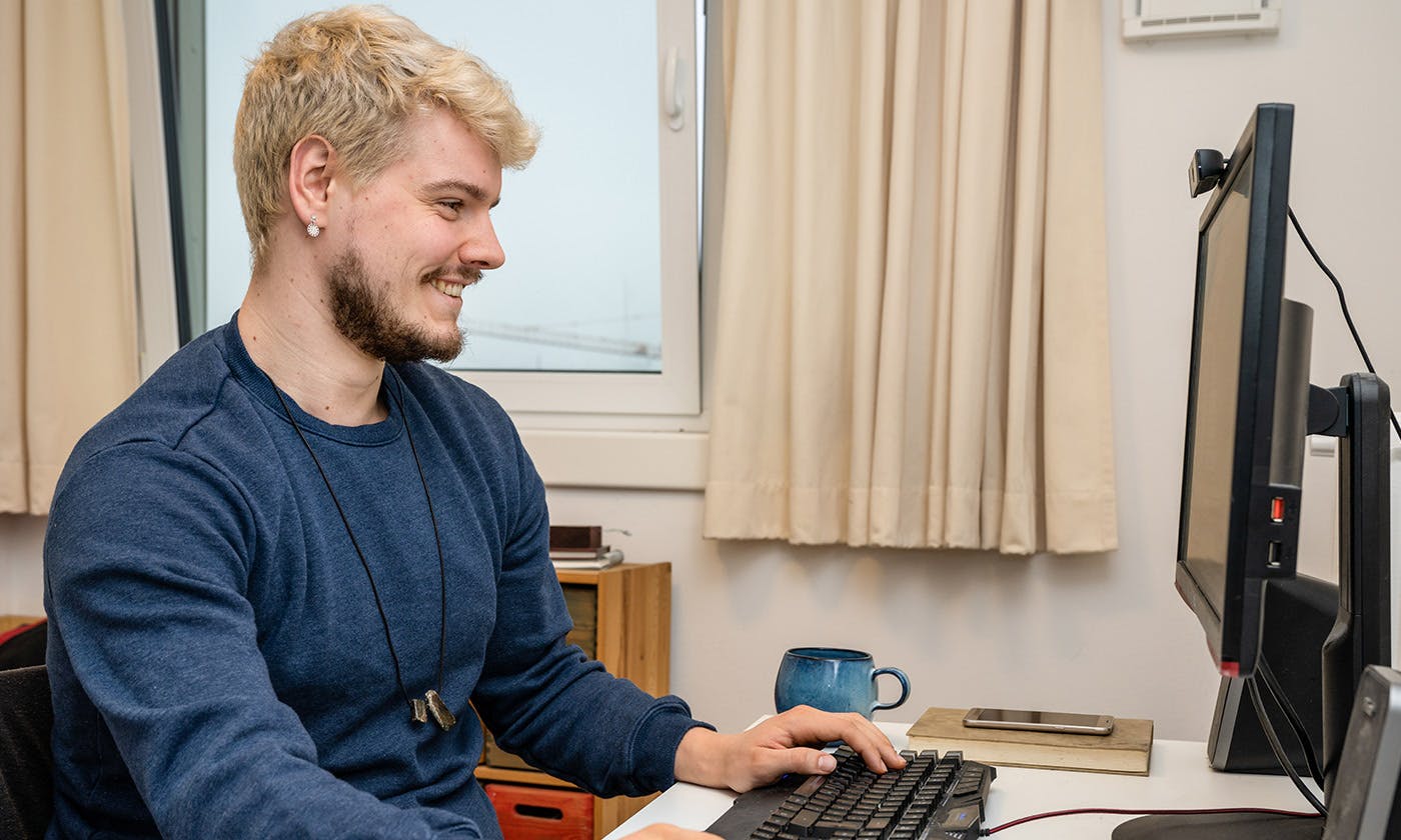 A young caucasian male on the computer