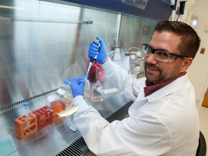 Male scientist filling a bottle