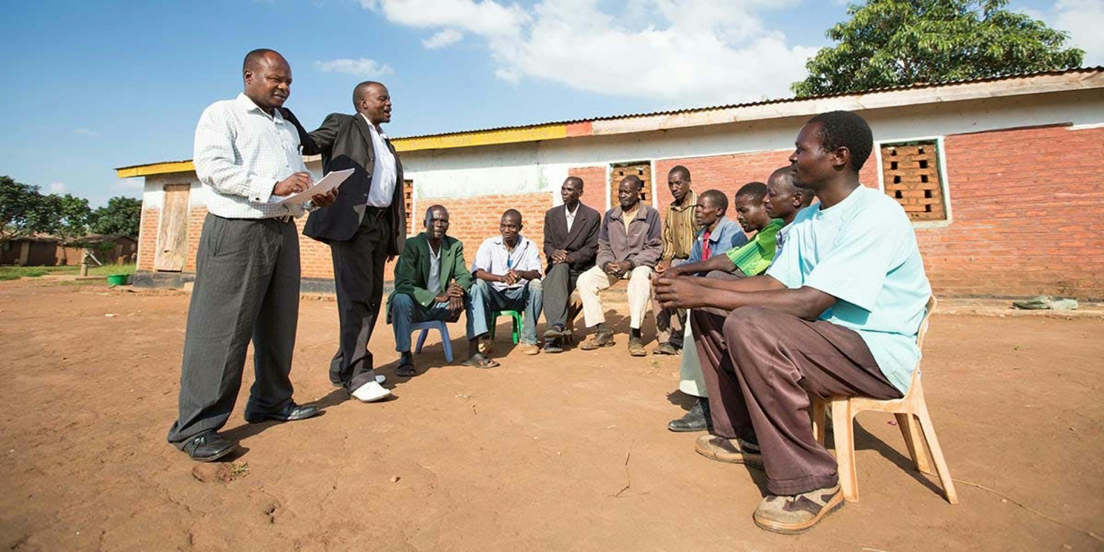 Group of men having discussion outdoors