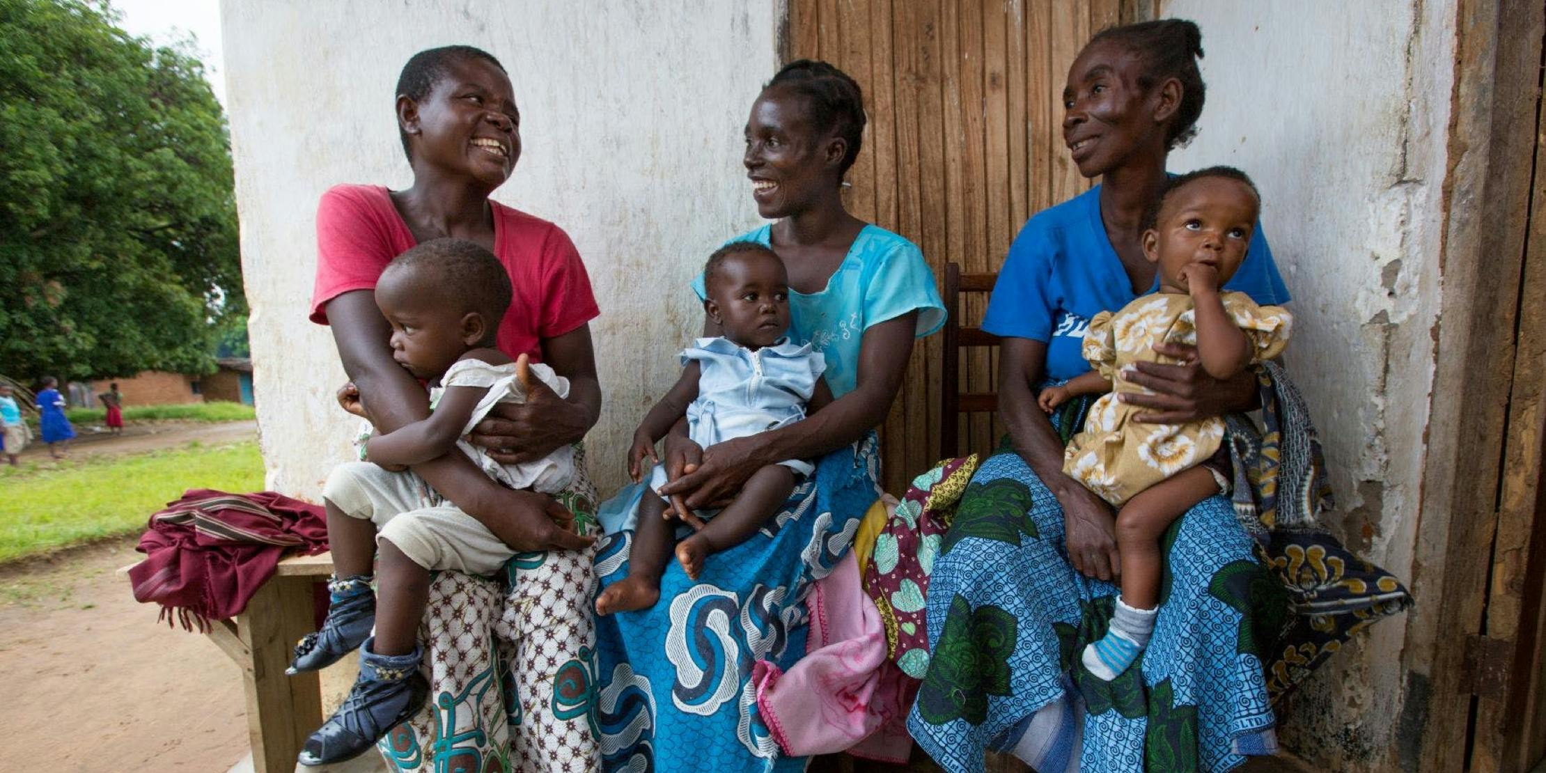 Three mothers each holding their children Three mothers each holding their children