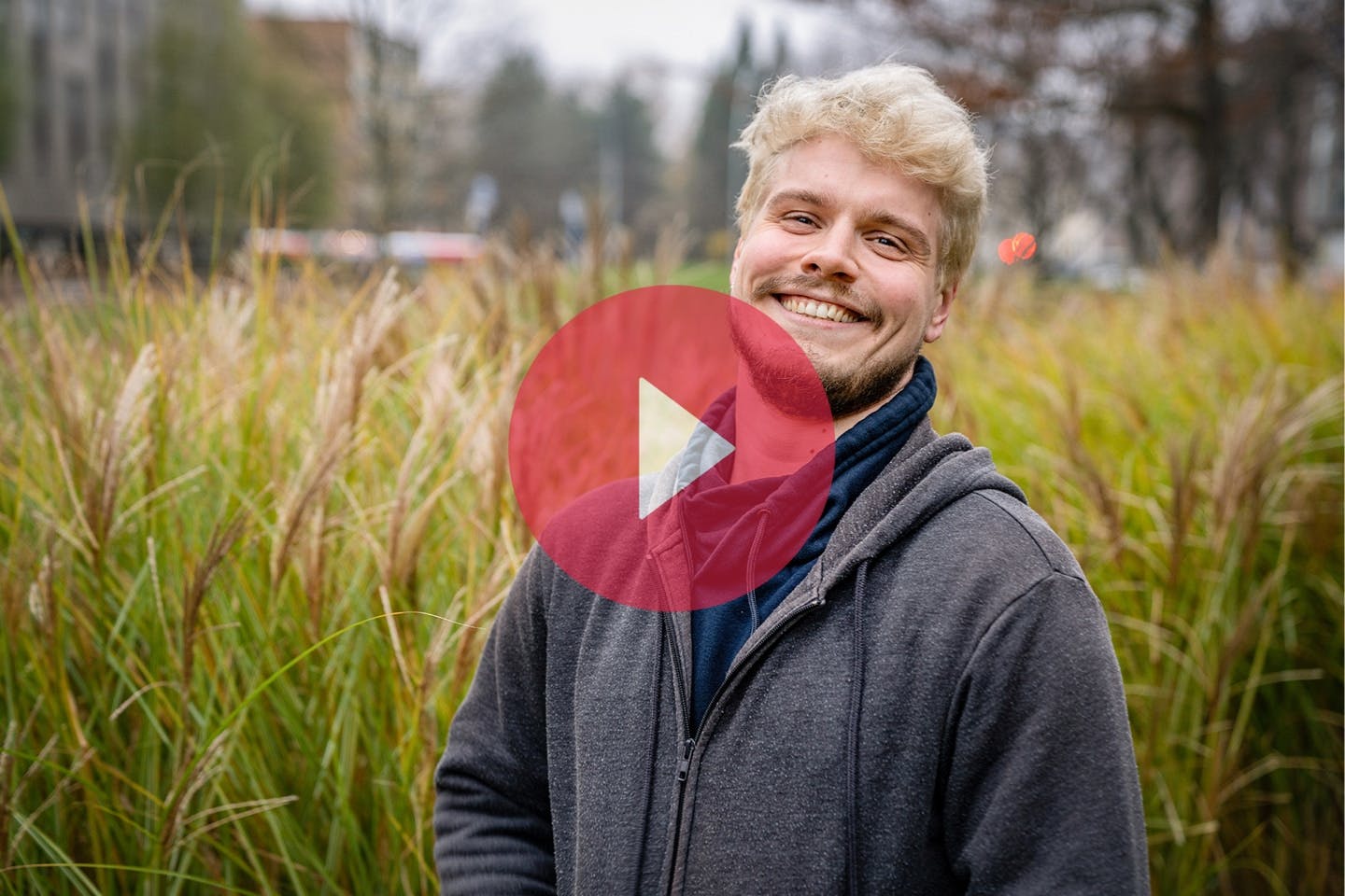 Person living with HIV smiling in Hamburg outdoors