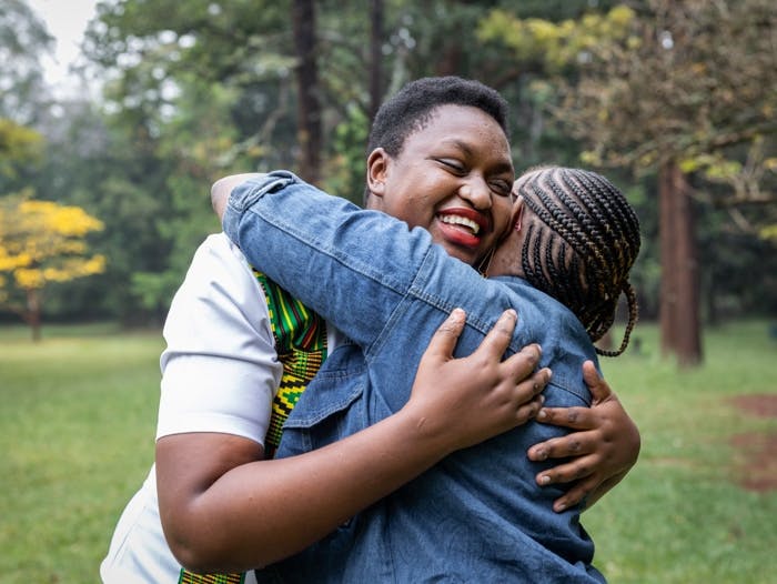 Young woman living with HIV photographed with her friend in Nairobi, Kenya