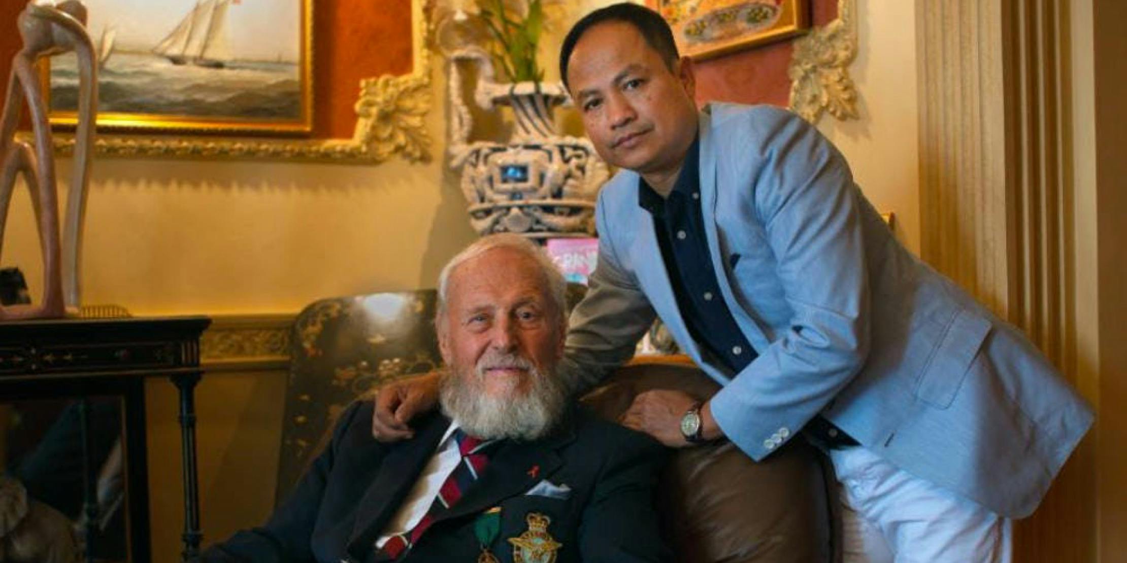 two men, one elderly and a younger in their sitting room