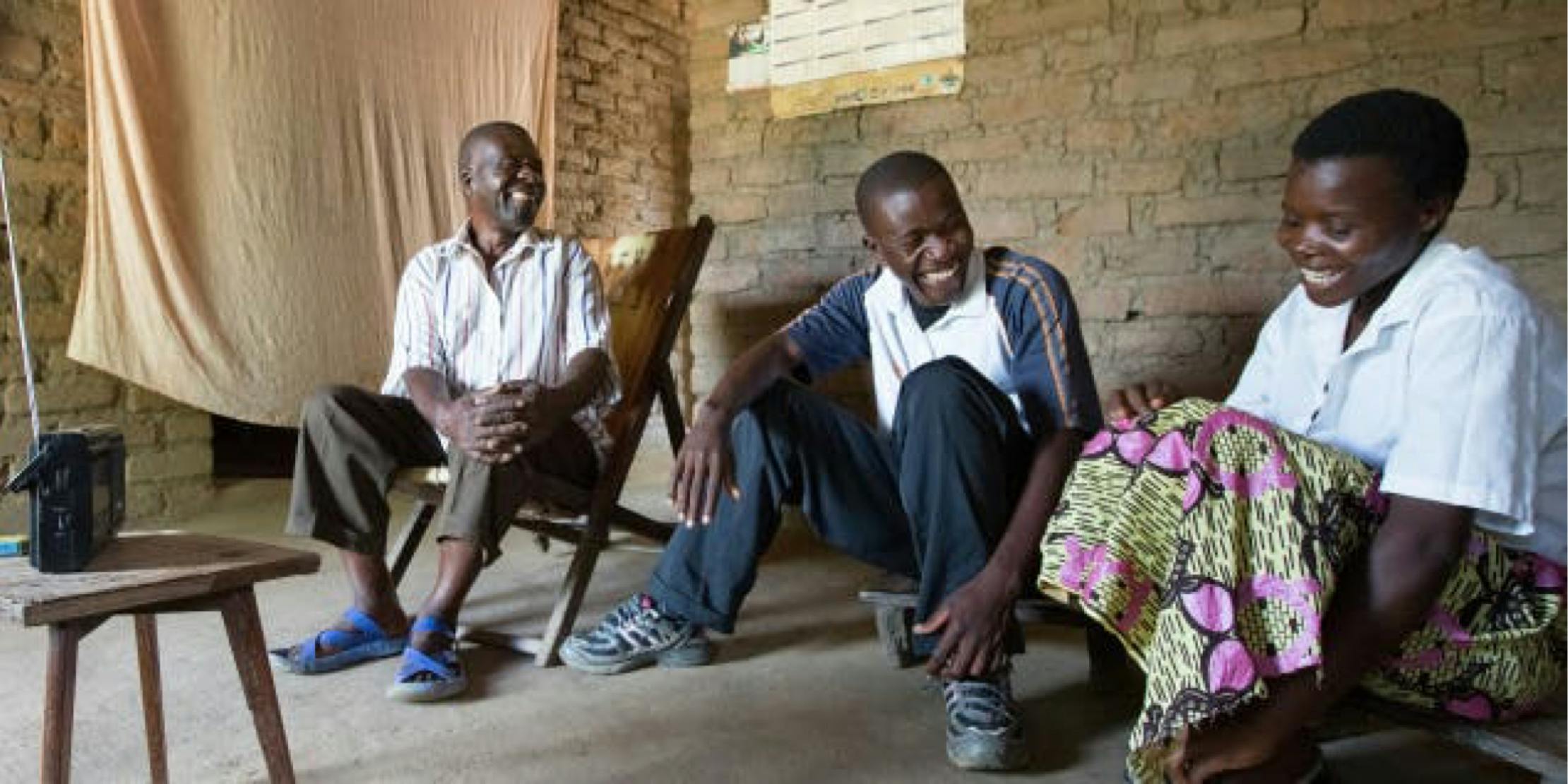 Two men and one woman laughing