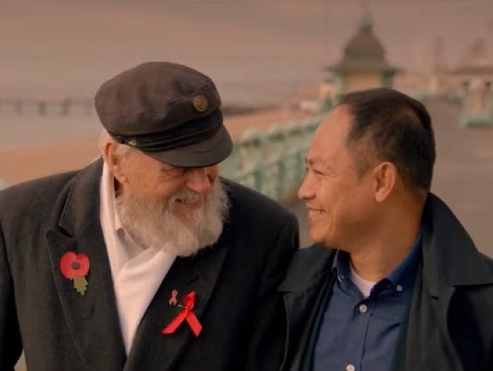 Two men looking at each other and smiling 