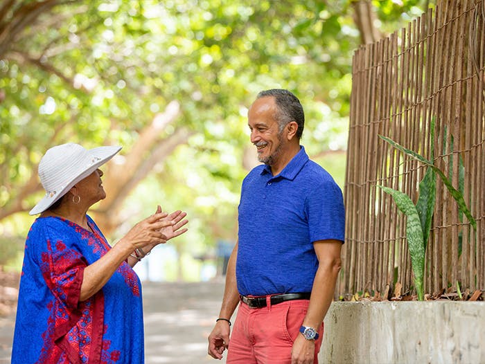 Smiling senior man talking to a woman in the park
