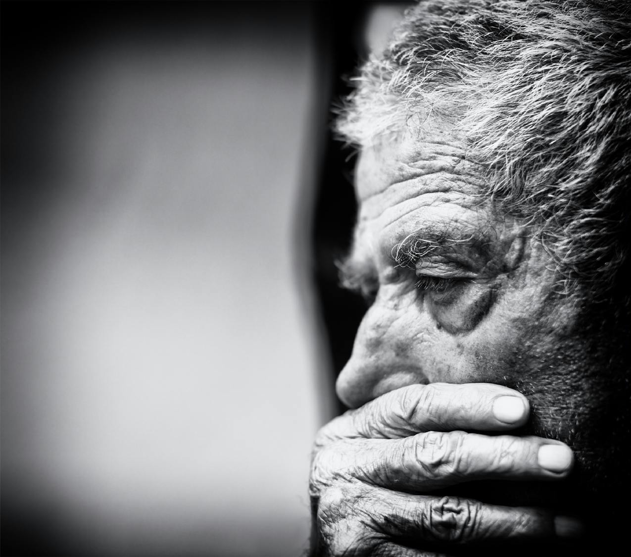 A black and white close-up of a senior man