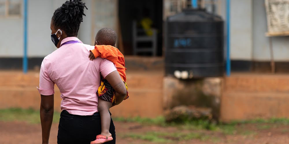 A person carrying a child