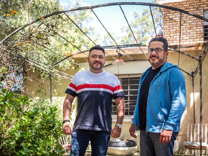 Two latino men standing in backyard in uruguay the man on the right is living with hiv