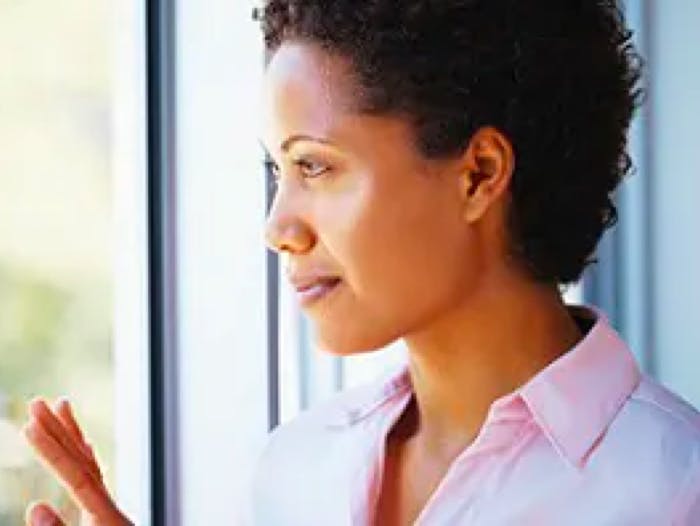 Closeup of woman looking out a window