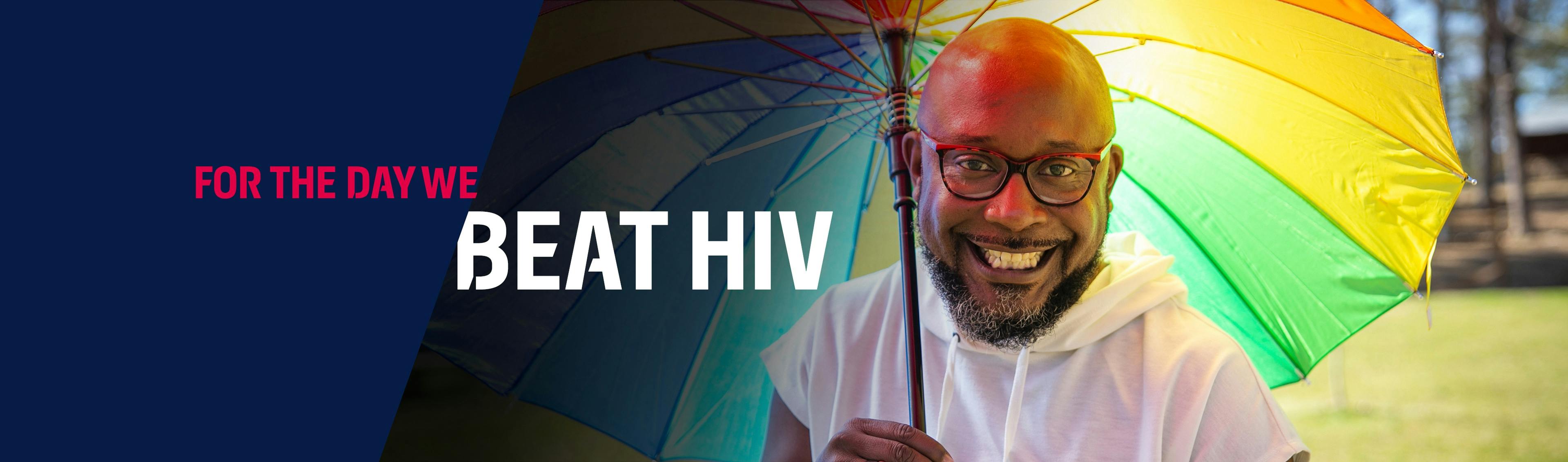 Black man living with HIV in USA holding a rainbow umbrella
